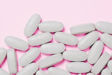 tablets on pink surface