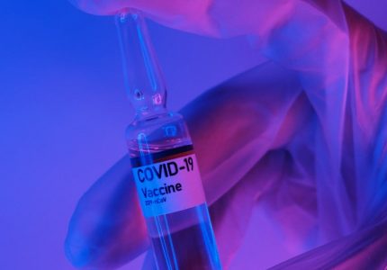 crop doctor demonstrating dose of vaccine against coronavirus in laboratory