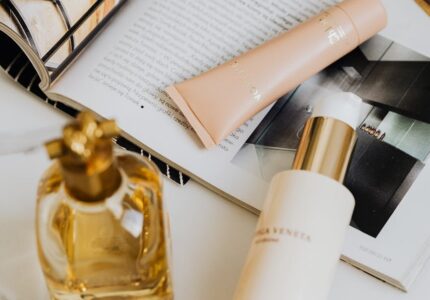 perfume and cosmetics lying on a fashion magazine